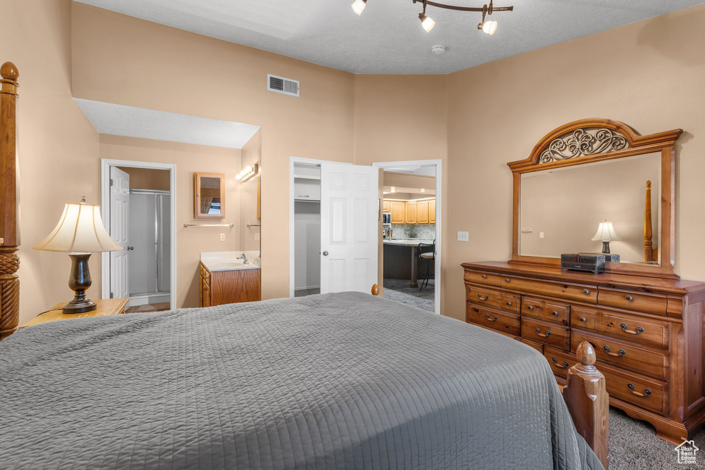 Bedroom featuring carpet and connected bathroom