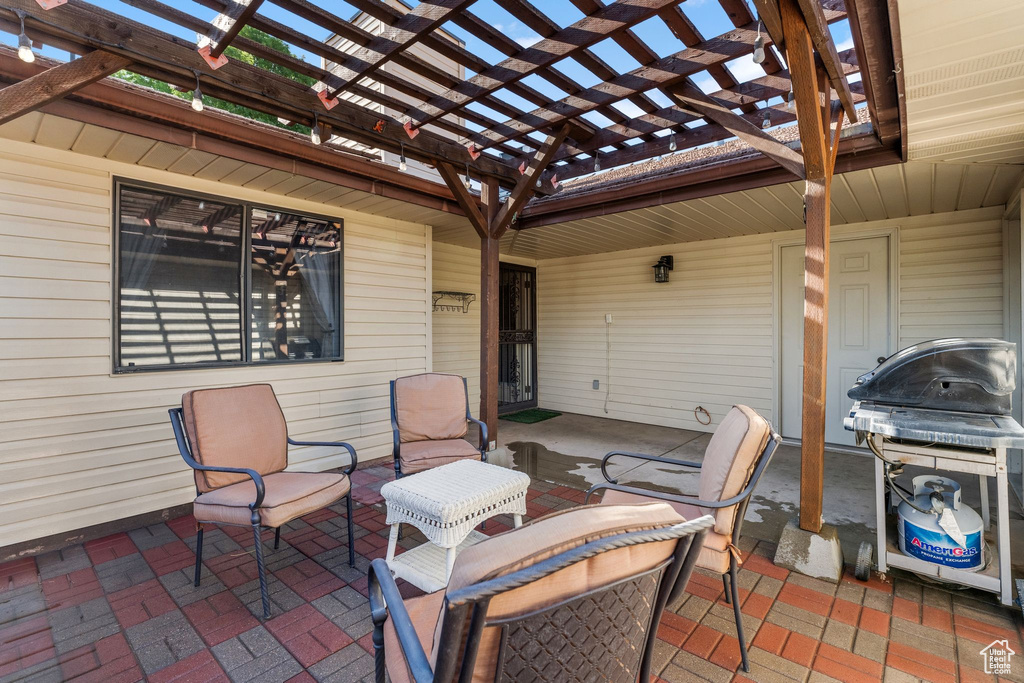 View of patio featuring a pergola and area for grilling