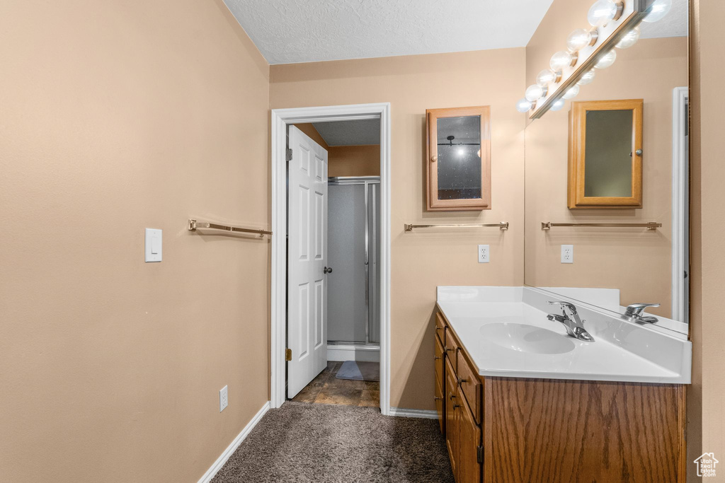 Bathroom with vanity and a shower with shower door