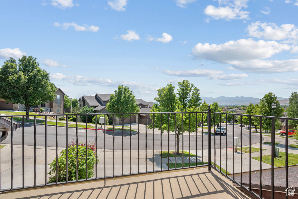 Balcony featuring a residential view and a mountain view