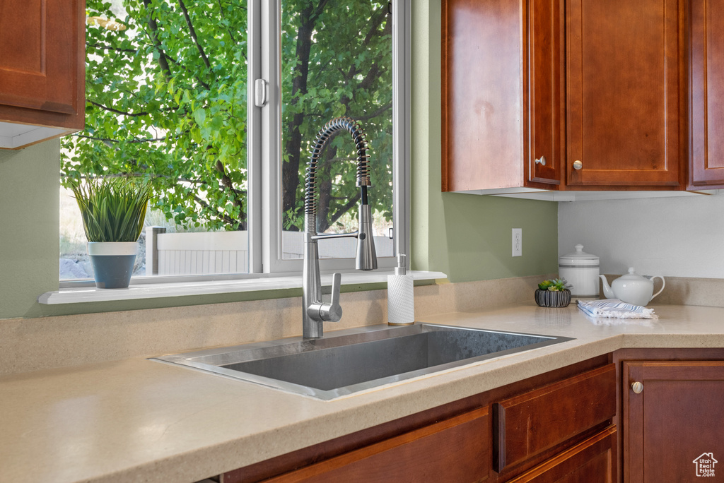 Kitchen featuring light countertops and brown cabinetry