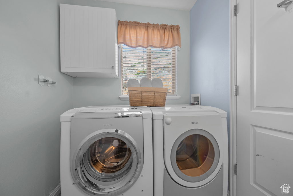 Laundry room with cabinet space and washing machine and dryer