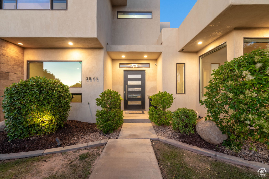 View of exterior entry featuring stucco siding