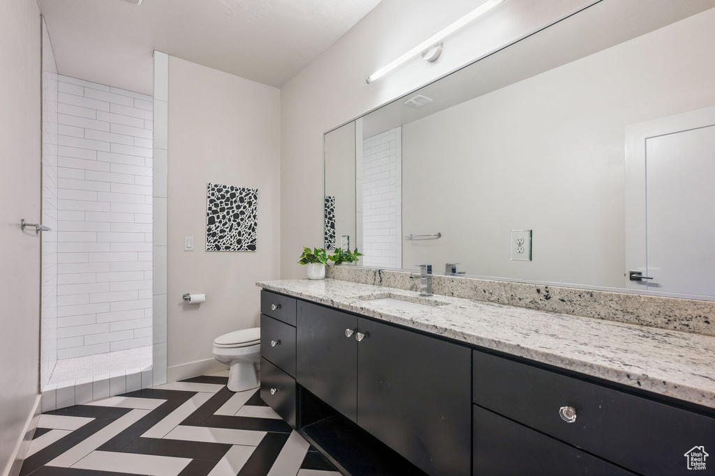 Full bathroom with vanity and a tile shower