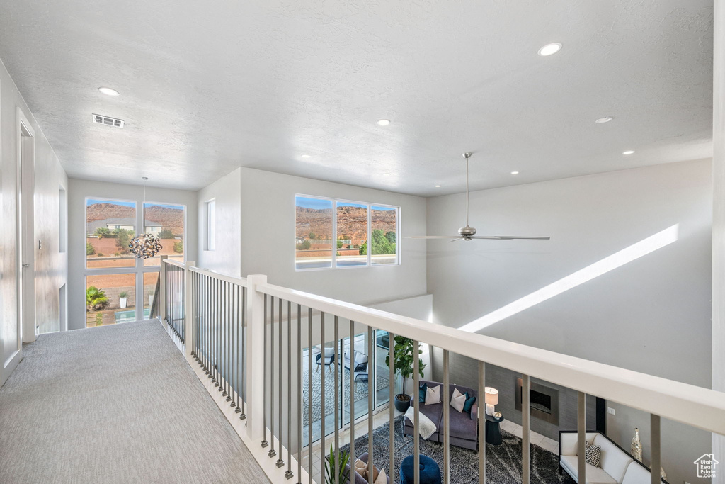 Corridor with recessed lighting and carpet floors