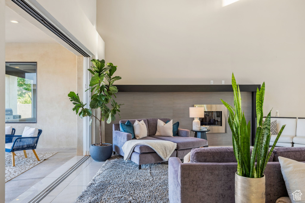 Living room featuring light tile patterned floors and recessed lighting