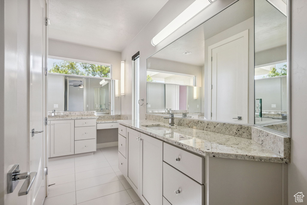 Full bath with vanity and tile patterned floors