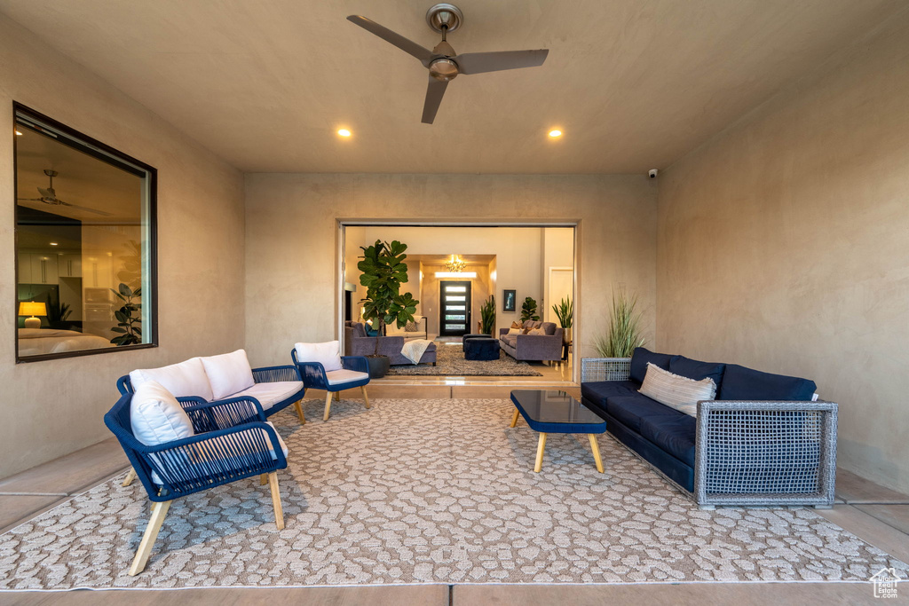 View of patio with an outdoor living space and ceiling fan
