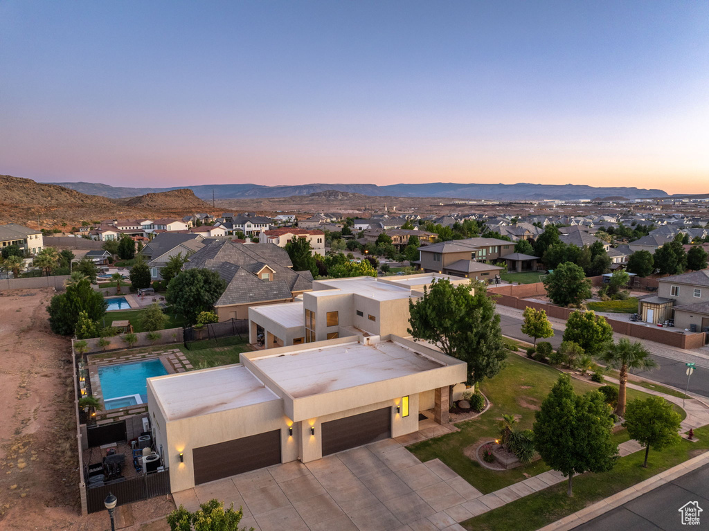 Aerial view of residential area featuring a mountainous background
