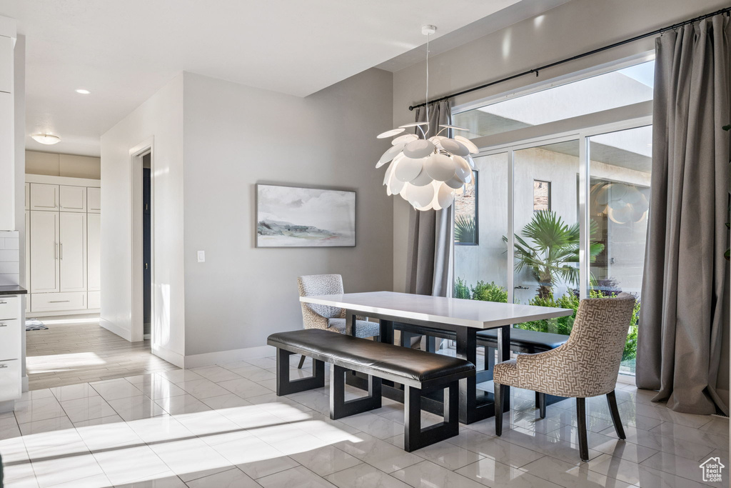Dining room with a chandelier and recessed lighting