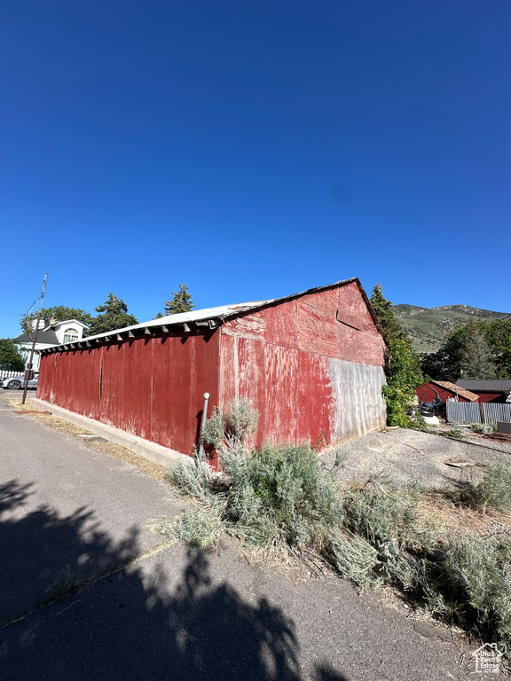 View of side of home featuring an outdoor structure