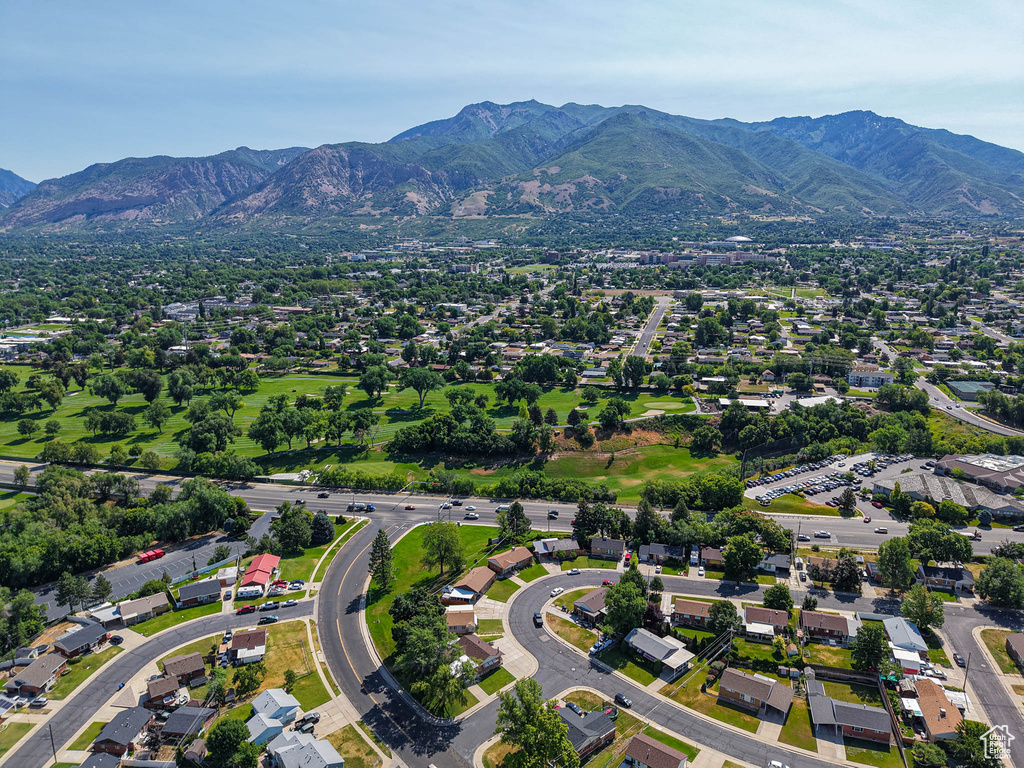 Aerial view of property and surrounding area with a mountain backdrop