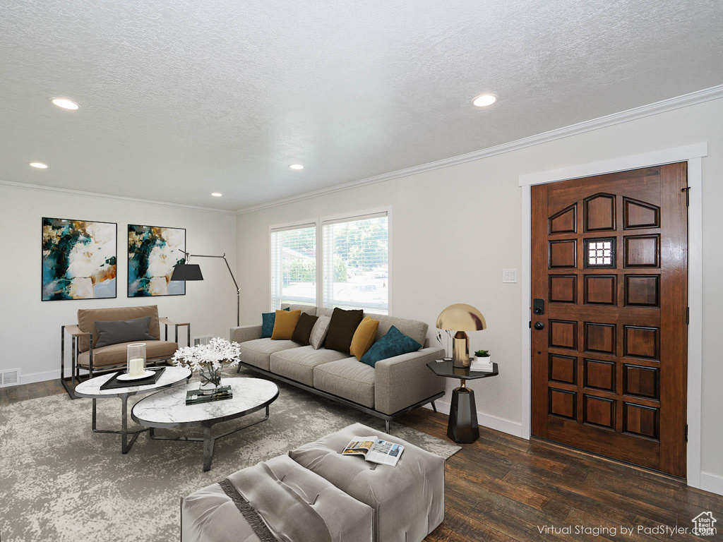 Living room featuring dark wood-style floors, ornamental molding, a textured ceiling, and recessed lighting