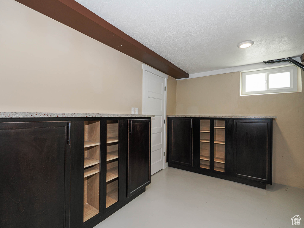 Below grade area with a textured ceiling