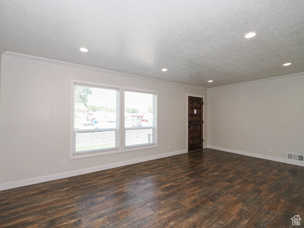 Unfurnished room featuring crown molding, a textured ceiling, dark wood-style floors, and recessed lighting