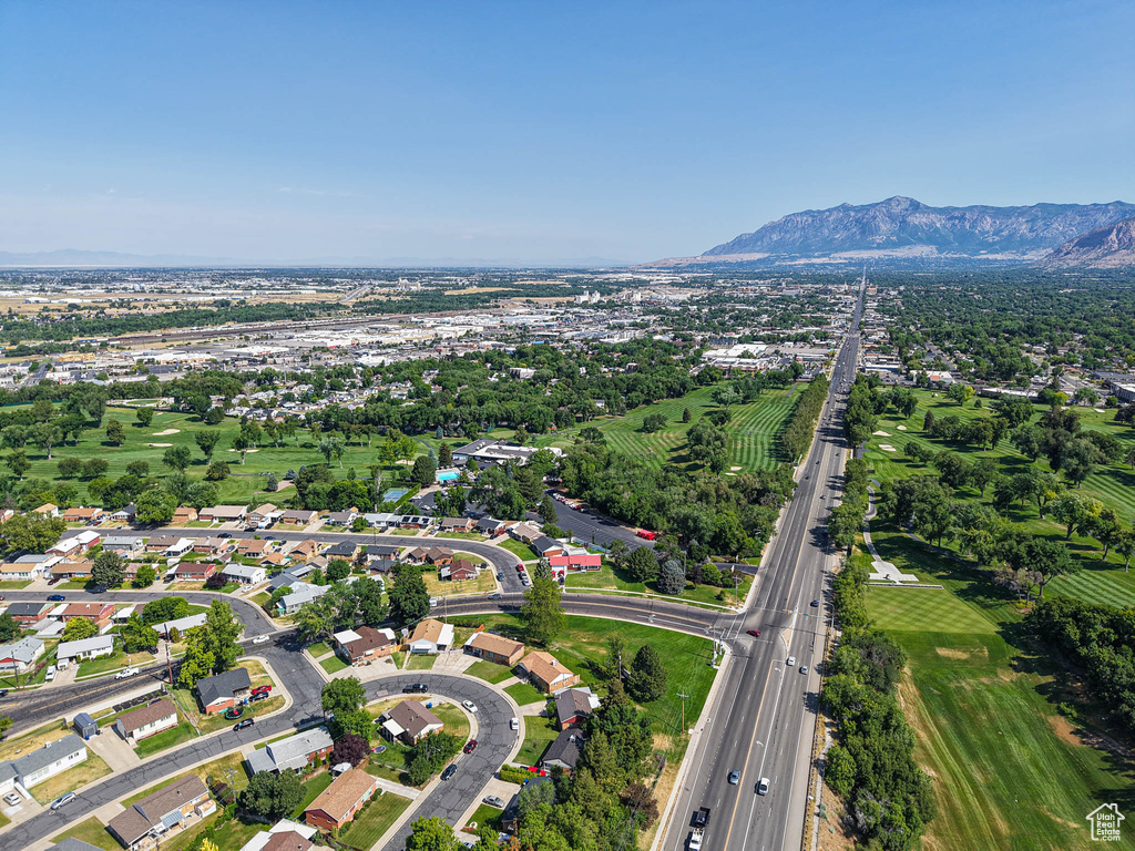 Aerial view of property and surrounding area with a mountainous background