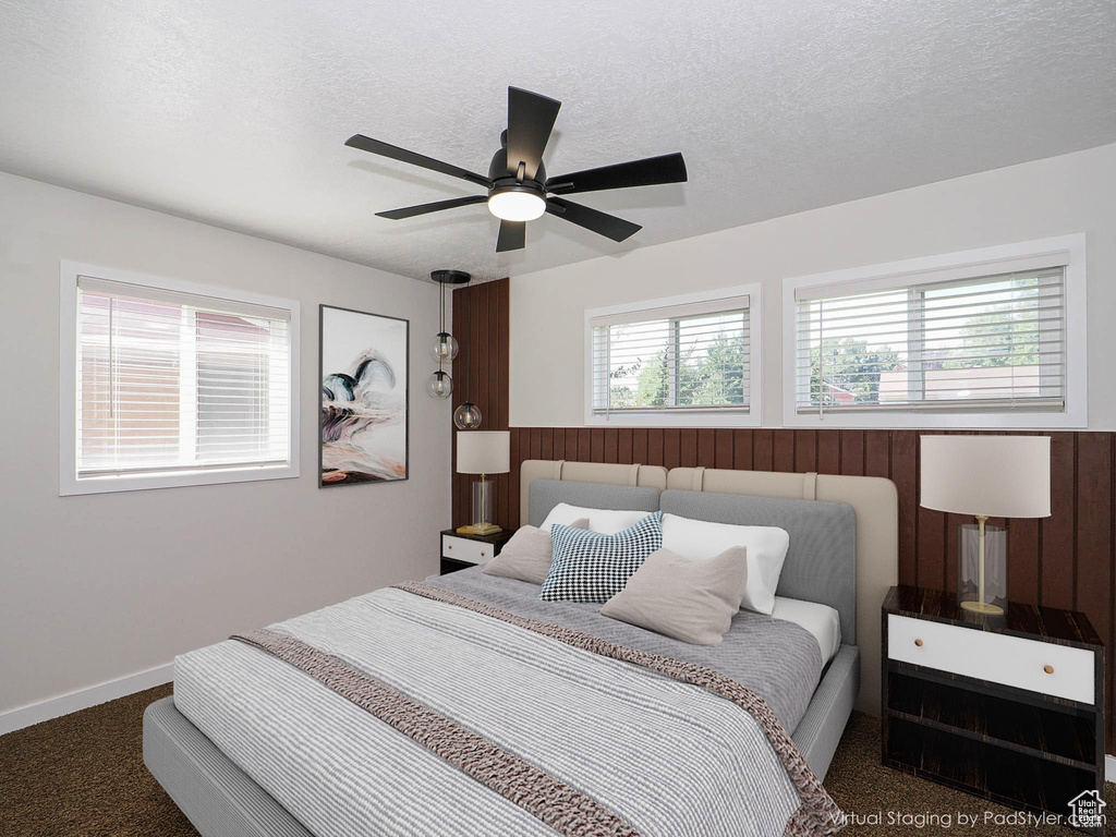 Bedroom with carpet, a ceiling fan, and a textured ceiling