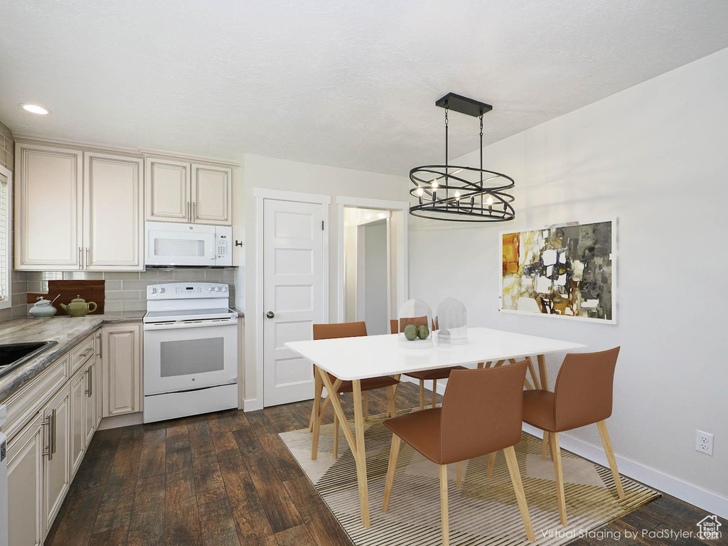 Kitchen with white appliances, a chandelier, dark wood-style floors, decorative backsplash, and recessed lighting