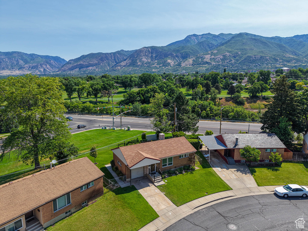 Aerial view of property and surrounding area with a mountain backdrop