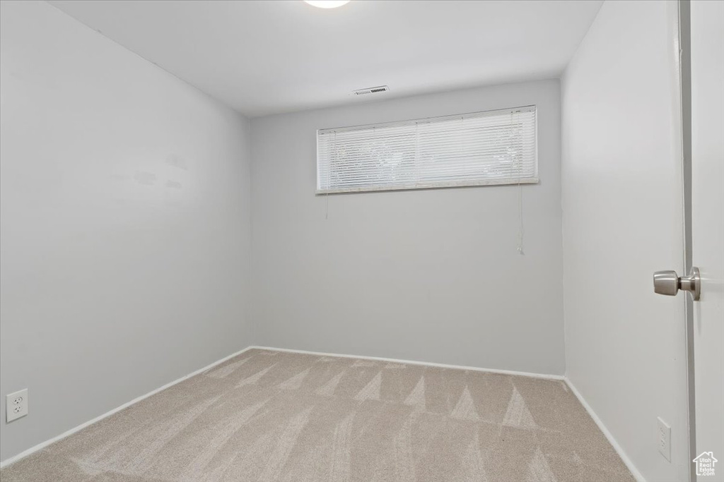 Carpeted spare room with baseboards