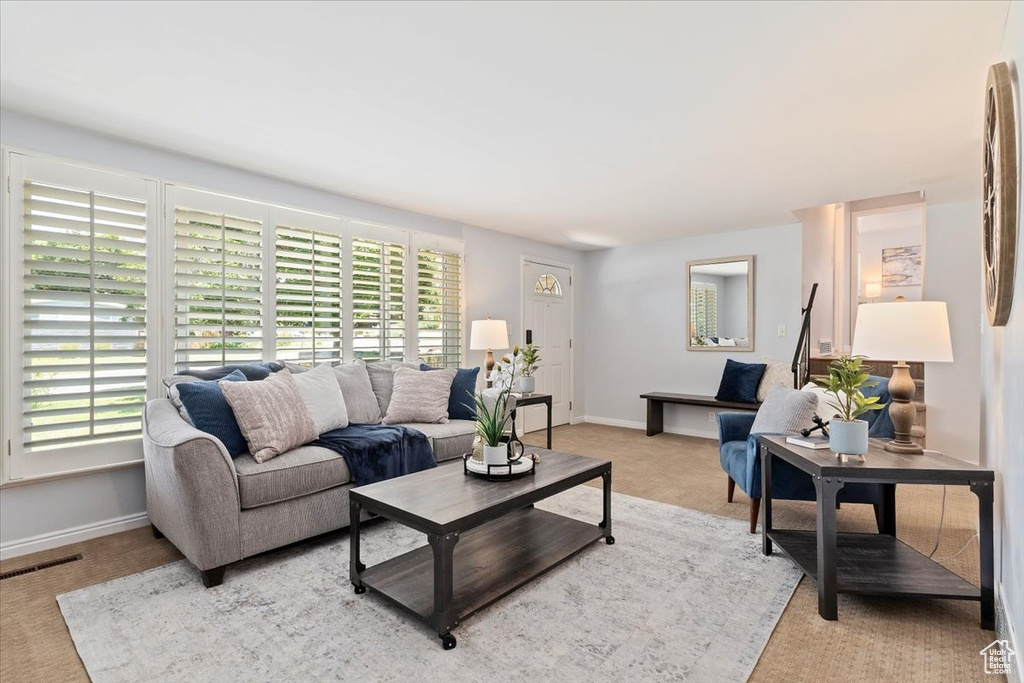 Living room featuring light carpet and baseboards