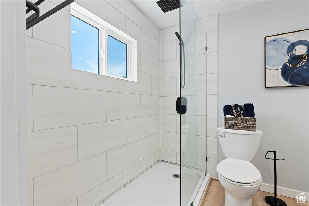 Full bathroom with tiled shower and toilet