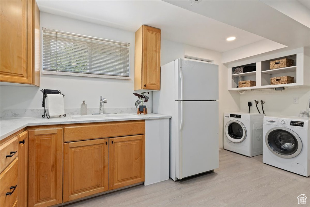 Laundry area with light wood-style floors, separate washer and dryer, and recessed lighting