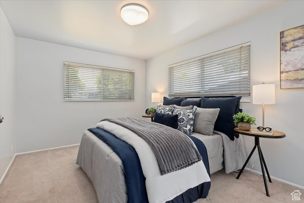 Bedroom featuring light colored carpet