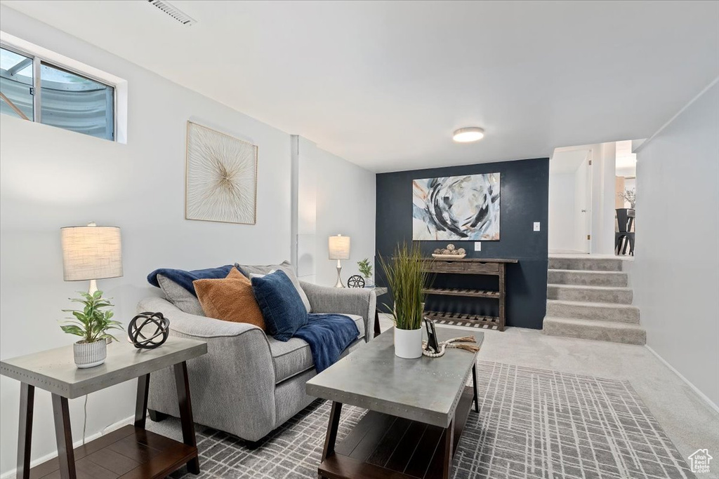 Living room featuring stairs and baseboards