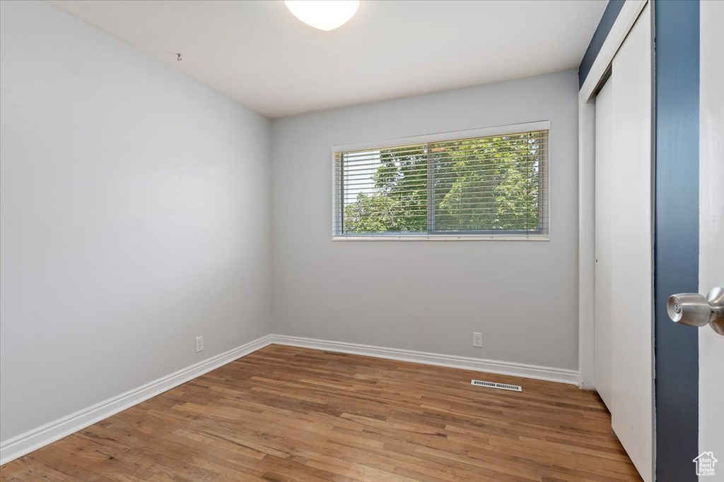 Unfurnished bedroom with light wood finished floors and a closet