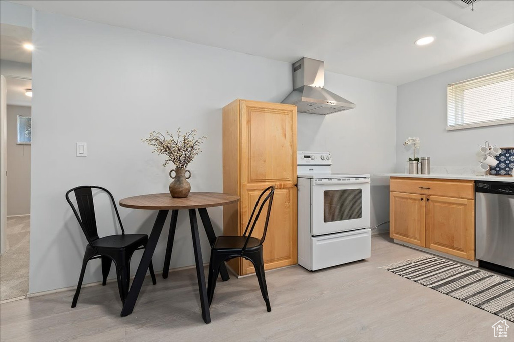 Kitchen featuring electric stove, wall chimney range hood, stainless steel dishwasher, light wood-style flooring, and recessed lighting