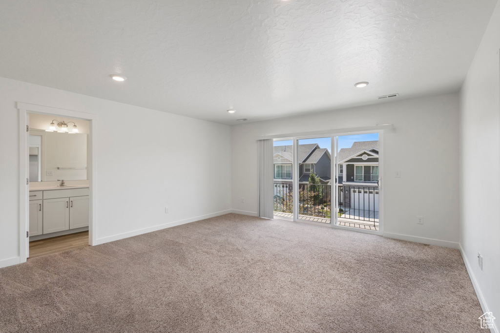 Unfurnished room with light carpet, a chandelier, and recessed lighting