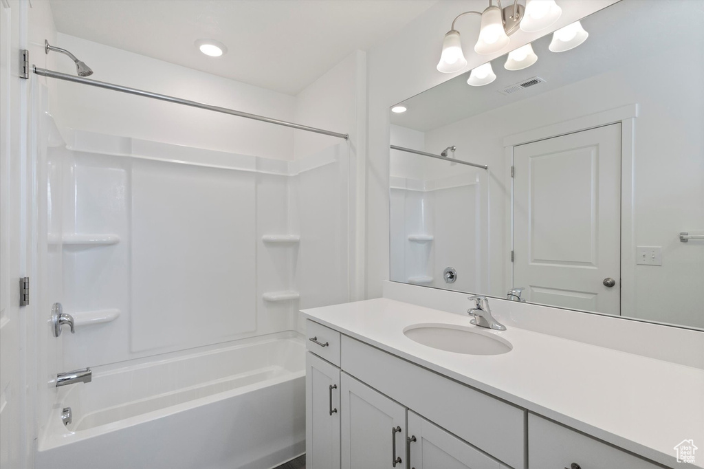 Bathroom featuring bathtub / shower combination, vanity, and recessed lighting