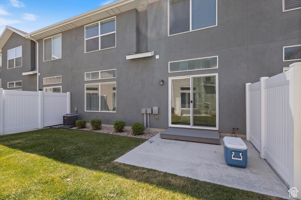 Back of house with stucco siding and a patio