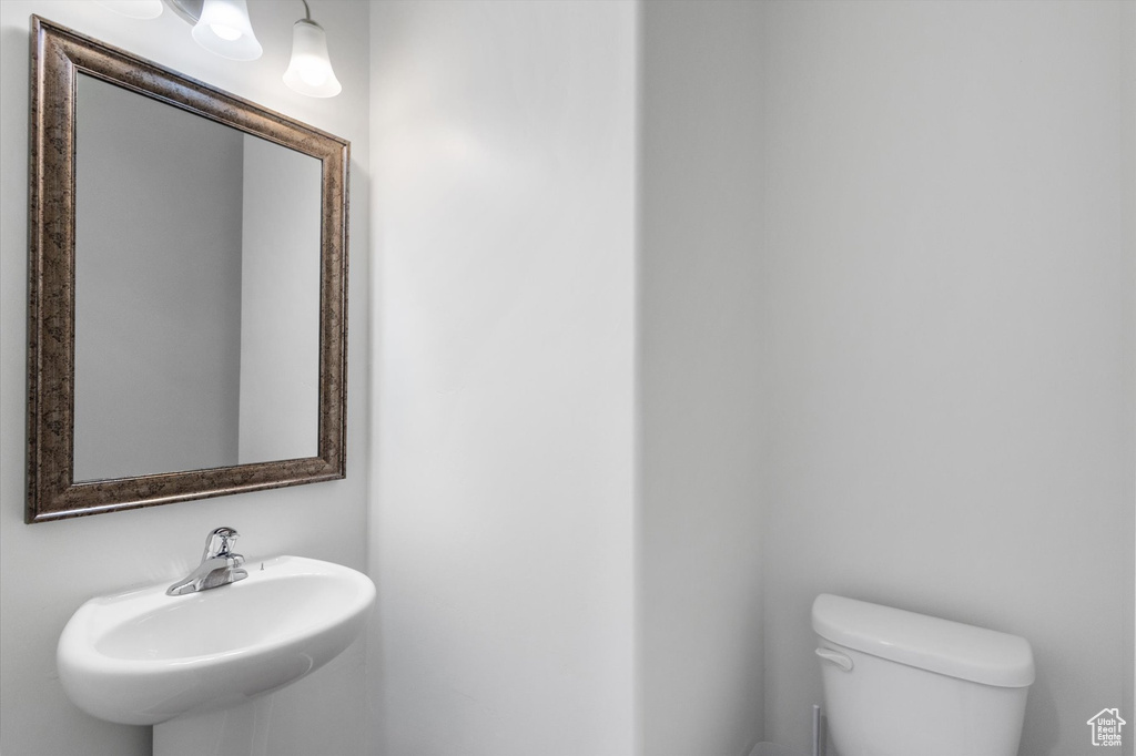 Half bath with a sink and toilet