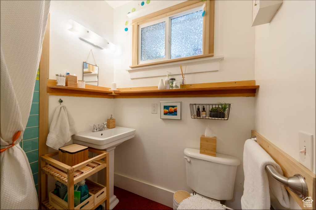 Bathroom with toilet and baseboards