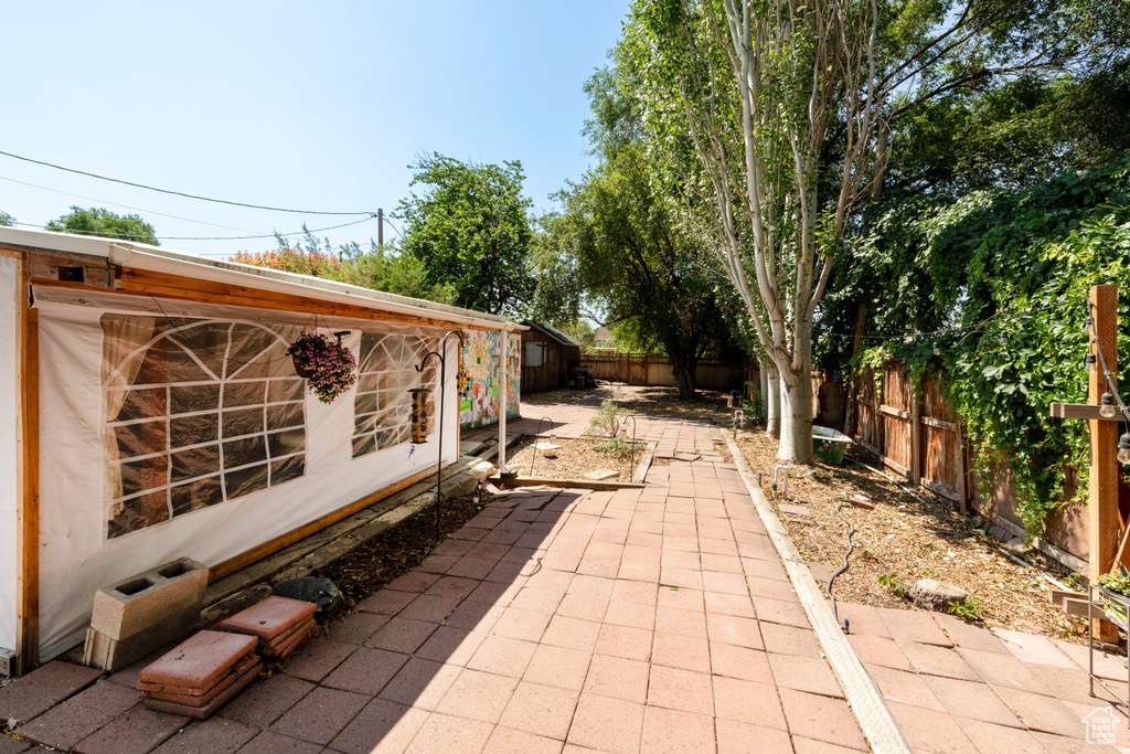 Fenced backyard with a patio