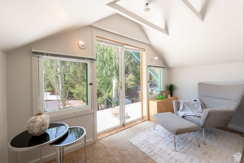 Living area with vaulted ceiling and carpet