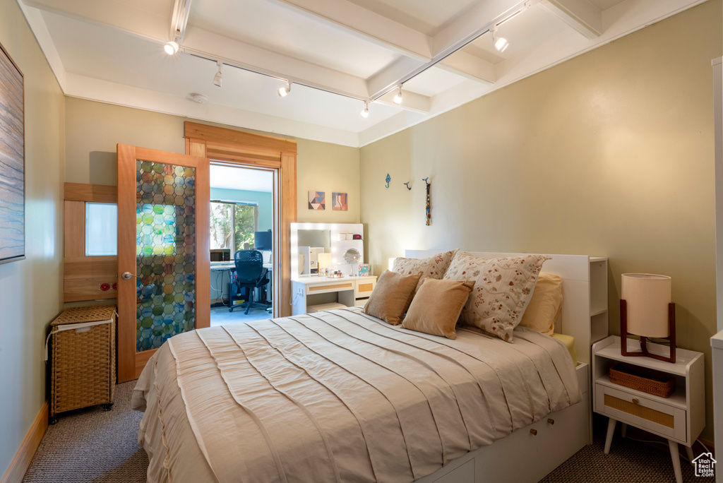 Bedroom with rail lighting, carpet flooring, and a desk
