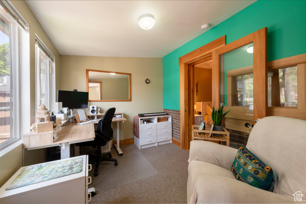 Office space featuring healthy amount of natural light and carpet