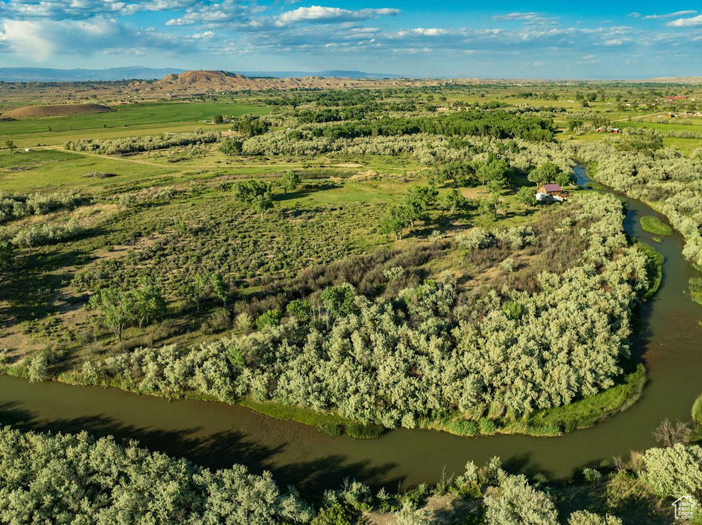 Aerial view of property and surrounding area featuring a mountain backdrop