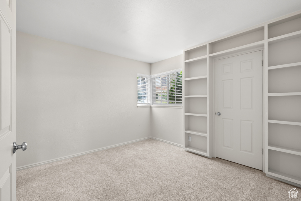 Unfurnished bedroom featuring carpet and baseboards