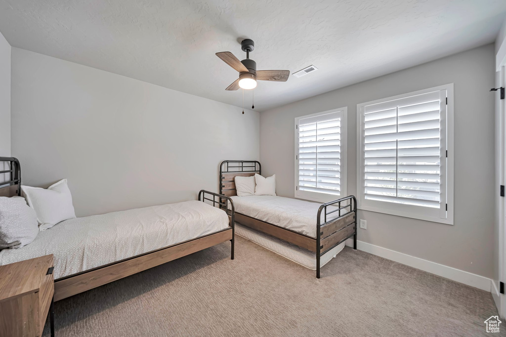 Bedroom with carpet and a ceiling fan