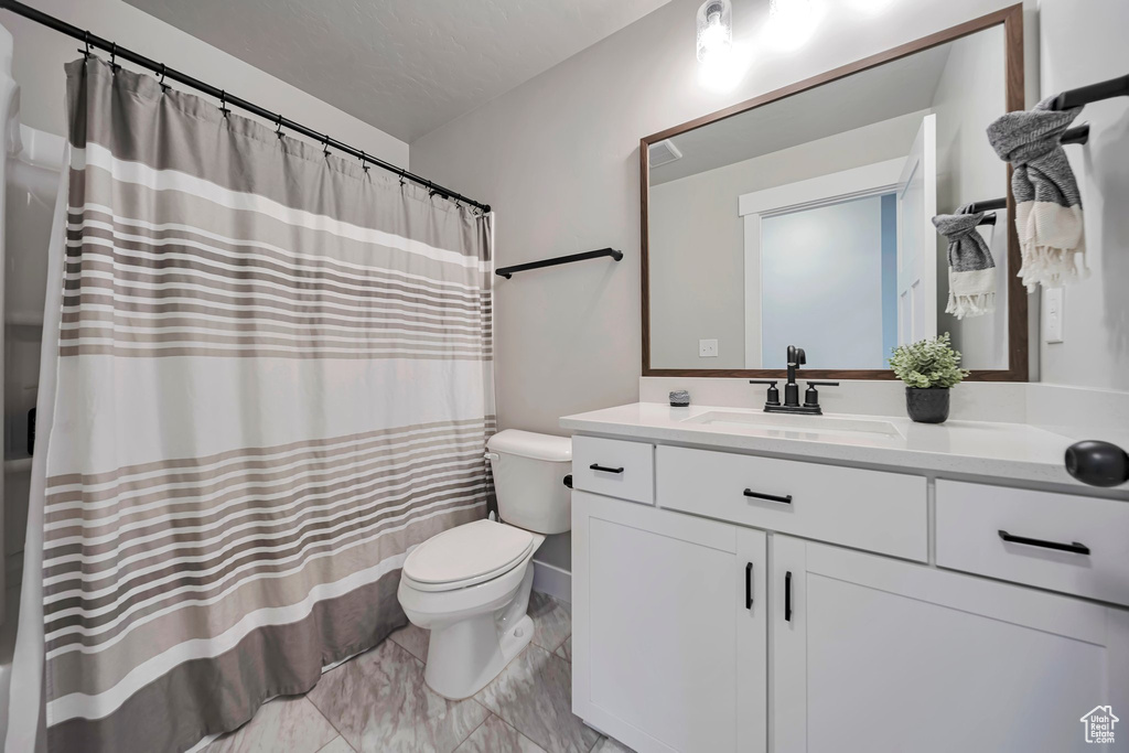 Bathroom with vanity and curtained shower