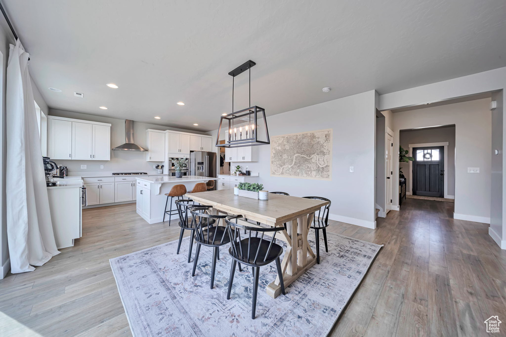Dining room featuring light wood-style floors, recessed lighting, and a chandelier
