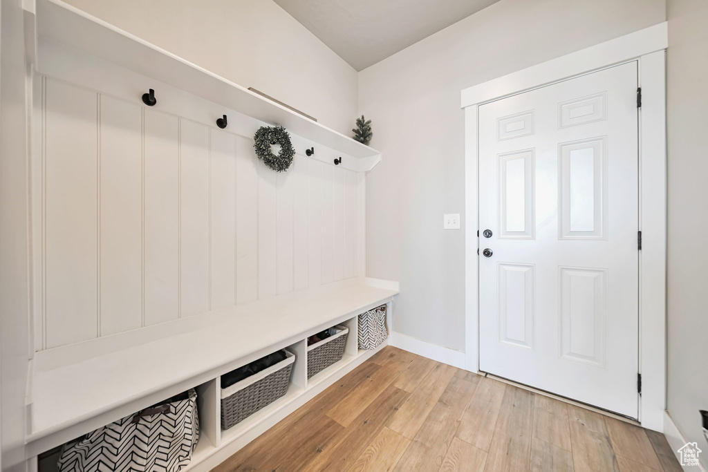 Mudroom featuring light wood-type flooring and baseboards