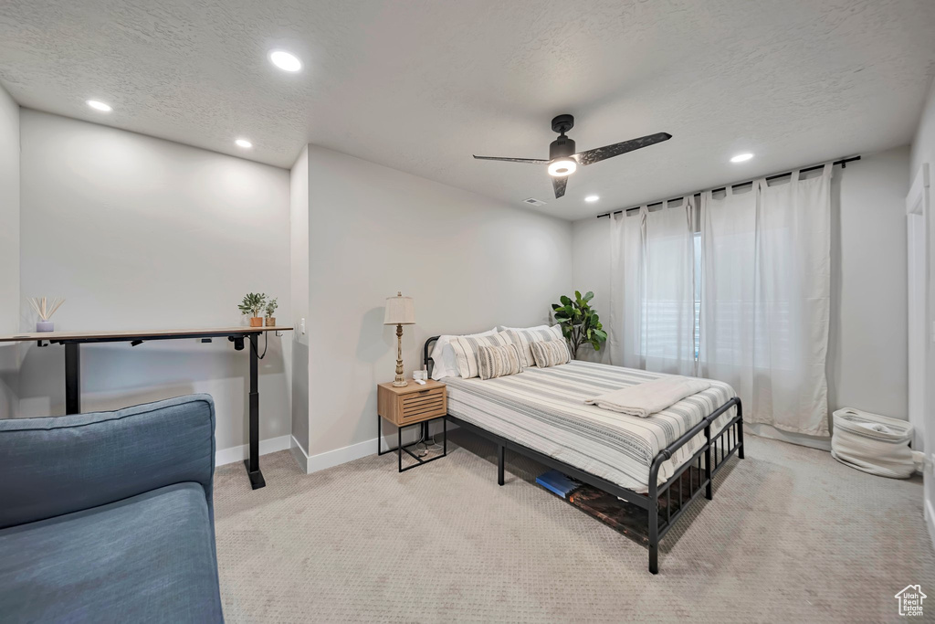 Carpeted bedroom with recessed lighting, a textured ceiling, and a ceiling fan