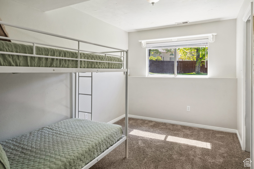Carpeted bedroom with baseboards