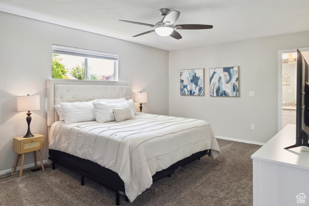 Bedroom featuring dark colored carpet, baseboards, and a ceiling fan
