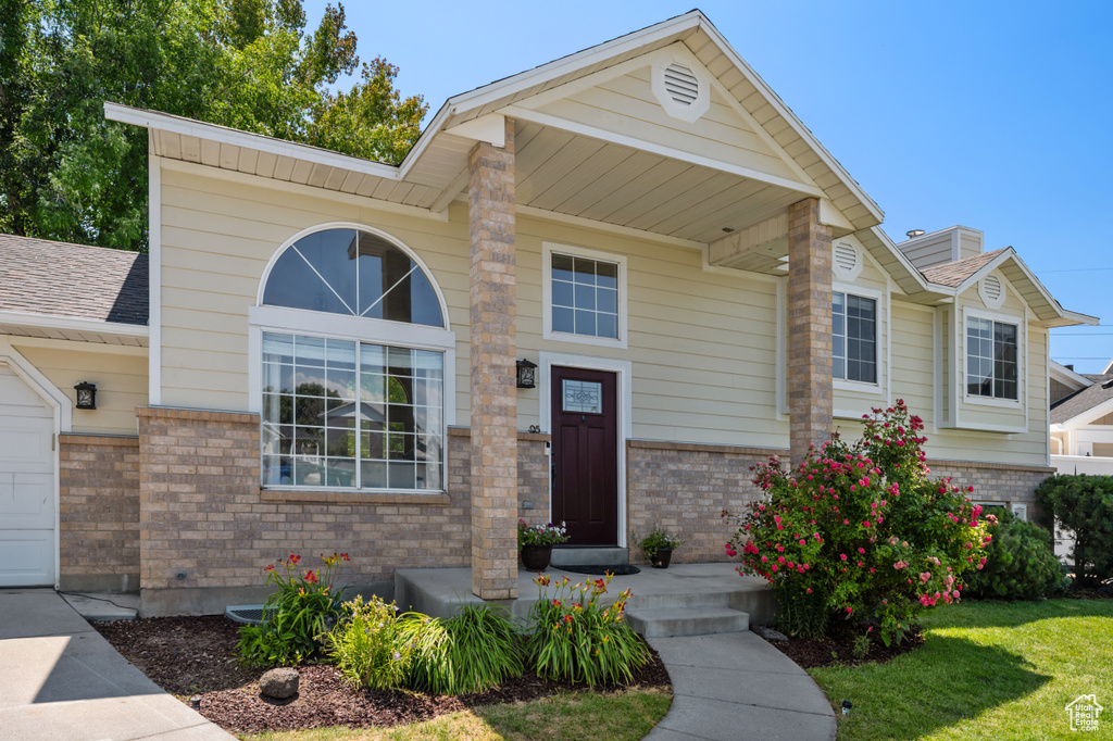 View of front facade featuring brick siding and a front lawn